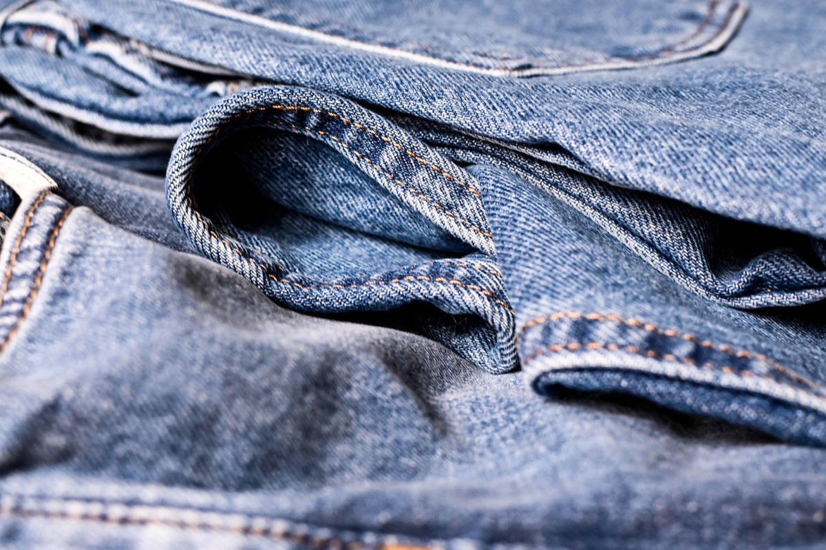 Eco-friendly organic cotton clothing displayed on a wooden rack