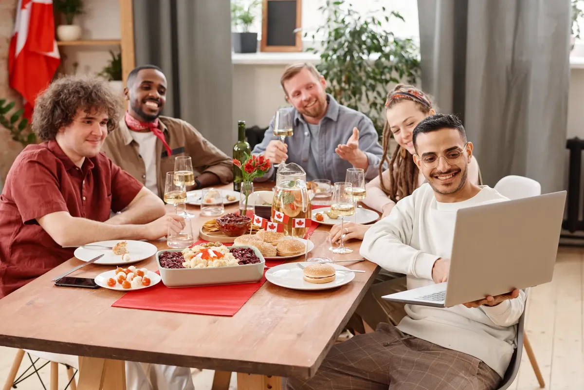 Friends gathered indoors for a festive Canada Day celebration with food and drinks.